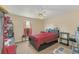 Bedroom with ceiling fan, window with pink curtains, and shelving along the walls at 510 Lobelia Dr, Davenport, FL 33837
