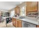 Well-lit kitchen with stainless steel appliances and mosaic tile backsplash adding a touch of modern style at 510 Lobelia Dr, Davenport, FL 33837