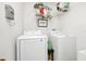 Laundry room with a washer, dryer, and wire shelving for storage at 510 Lobelia Dr, Davenport, FL 33837