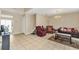 Open-concept living room with tile flooring, chandelier, and comfortable seating arrangement, ideal for relaxation at 510 Lobelia Dr, Davenport, FL 33837