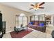 Cozy living room featuring plush seating, a ceiling fan, and a bright window at 510 Lobelia Dr, Davenport, FL 33837