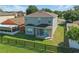 Aerial view of a home with a spacious backyard and a wooden fence, perfect for outdoor enjoyment at 5107 Ne 122Nd Blvd, Oxford, FL 34484