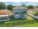 Aerial view of a home with a spacious backyard and a wooden fence, perfect for outdoor enjoyment at 5107 Ne 122Nd Blvd, Oxford, FL 34484