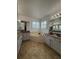 Bright bathroom featuring white cabinets, granite counters, and a soaking tub at 5107 Ne 122Nd Blvd, Oxford, FL 34484