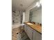 Bathroom with white marble shower, granite counters and white cabinets at 5107 Ne 122Nd Blvd, Oxford, FL 34484