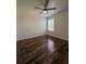 Bedroom featuring wood-look floors and a ceiling fan at 5107 Ne 122Nd Blvd, Oxford, FL 34484