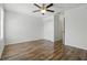 Bedroom featuring wood floor, ceiling fan and closet with en-suite bathroom at 5107 Ne 122Nd Blvd, Oxford, FL 34484