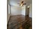 Spacious bedroom featuring wood flooring, a ceiling fan, and a large closet at 5107 Ne 122Nd Blvd, Oxford, FL 34484
