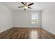 Cozy bedroom with wood floor, ceiling fan, and window that provides natural light at 5107 Ne 122Nd Blvd, Oxford, FL 34484