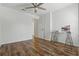 Bright bedroom featuring wood floor, ceiling fan and glass desk at 5107 Ne 122Nd Blvd, Oxford, FL 34484