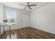 Bedroom with wood floors, ceiling fan and large window provides natural light at 5107 Ne 122Nd Blvd, Oxford, FL 34484