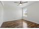 Bedroom featuring wood floor, ceiling fan and window provides natural light at 5107 Ne 122Nd Blvd, Oxford, FL 34484
