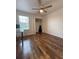 Bedroom with a ceiling fan, natural light, and wood floors at 5107 Ne 122Nd Blvd, Oxford, FL 34484