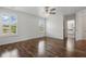 Bright and airy bedroom with hardwood floors, ceiling fan, and plantation shutters on the windows at 5107 Ne 122Nd Blvd, Oxford, FL 34484