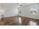 Spacious bedroom with hardwood floors, neutral walls, and large windows with plantation shutters at 5107 Ne 122Nd Blvd, Oxford, FL 34484