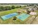Aerial view of a community featuring tennis and basketball courts, a playground, and green spaces for outdoor recreation at 5107 Ne 122Nd Blvd, Oxford, FL 34484