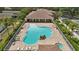 Relaxing community pool and hot tub with lounge chairs, landscaping, and a nearby building for residents to enjoy at 5107 Ne 122Nd Blvd, Oxford, FL 34484