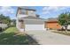 Beautiful two-story home with a spacious driveway and well-maintained landscaping and modern exterior at 5107 Ne 122Nd Blvd, Oxford, FL 34484