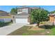 Beautiful two-story home with a spacious driveway and well-maintained landscaping and modern exterior at 5107 Ne 122Nd Blvd, Oxford, FL 34484