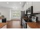 Modern kitchen featuring stainless steel appliances, ample countertop space, and an adjacent dining area at 5107 Ne 122Nd Blvd, Oxford, FL 34484
