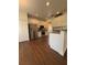 Modern kitchen featuring stainless steel appliances, white cabinetry, and wood floors at 5107 Ne 122Nd Blvd, Oxford, FL 34484