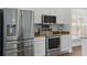 Close-up on stainless steel refrigerator, oven, and microwave in a well-lit kitchen at 5107 Ne 122Nd Blvd, Oxford, FL 34484