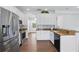 Bright kitchen with stainless steel appliances, granite countertops, and white cabinets at 5107 Ne 122Nd Blvd, Oxford, FL 34484