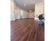 Spacious living room with hardwood floors, modern lighting, and a welcoming atmosphere at 5107 Ne 122Nd Blvd, Oxford, FL 34484