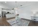Cozy living room with chandelier and view of modern kitchen at 5107 Ne 122Nd Blvd, Oxford, FL 34484