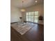 Living room featuring hardwood floors, neutral decor, modern lighting, and plenty of natural light at 5107 Ne 122Nd Blvd, Oxford, FL 34484