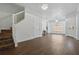 Bright and spacious living room featuring hardwood floors and modern lighting, stairs and entryway at 5107 Ne 122Nd Blvd, Oxford, FL 34484