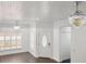 Bright and spacious living room featuring hardwood floors and modern lighting that lead to an entryway and stairs at 5107 Ne 122Nd Blvd, Oxford, FL 34484