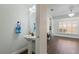 Stylish powder room featuring a modern pedestal sink and decorative fixtures with easy access to the main living area at 5107 Ne 122Nd Blvd, Oxford, FL 34484