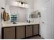 Bathroom featuring a large mirror and countertop with fixtures and cabinet storage at 532 Casanova Ct, Kissimmee, FL 34759