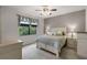 Comfortable bedroom with a queen-sized bed, soft lighting, and a window offering natural light at 532 Casanova Ct, Kissimmee, FL 34759