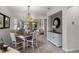 Open dining area with a rustic table and a stylish pendant light fixture at 532 Casanova Ct, Kissimmee, FL 34759