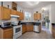Kitchen with tile floors, stainless steel appliances, wood cabinets, and a view into dining area at 532 Casanova Ct, Kissimmee, FL 34759