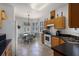 Open kitchen and dining area with tile floors, wood cabinets, and stainless steel appliances at 532 Casanova Ct, Kissimmee, FL 34759