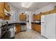 Well-lit kitchen with tile floors, dark countertops, stainless steel appliances, and light wood cabinets at 532 Casanova Ct, Kissimmee, FL 34759