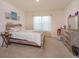 Serene bedroom featuring a wood bedframe, soft carpeting, and a light-filled atmosphere at 5367 Douglas Fir Dr, St Cloud, FL 34771