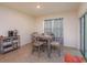 Cozy dining area with a modern table set, neutral colors, and a sliding glass door at 5367 Douglas Fir Dr, St Cloud, FL 34771