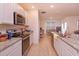 Bright kitchen with granite countertops, stainless steel appliances, and tile flooring at 5367 Douglas Fir Dr, St Cloud, FL 34771