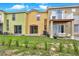 A multi-colored townhouse backyard with a small yard, and patio with seating at 540 Monroe Cir, Davenport, FL 33896