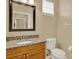 Bathroom featuring a granite countertop and a framed mirror above the sink at 540 Monroe Cir, Davenport, FL 33896