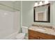 Bathroom featuring a white bathtub and a sink with a granite countertop and dark wood cabinet at 540 Monroe Cir, Davenport, FL 33896