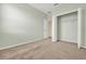 Carpeted bedroom featuring light green walls and a closet with wire shelving at 540 Monroe Cir, Davenport, FL 33896