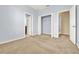 Bedroom featuring tan carpet, light blue walls, and a closet with white wire shelving at 540 Monroe Cir, Davenport, FL 33896