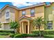 Charming townhome with colorful facade, well-maintained landscaping, and a welcoming entrance at 540 Monroe Cir, Davenport, FL 33896