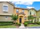 Cozy townhome with multiple units, manicured greenery, and a covered entrance at 540 Monroe Cir, Davenport, FL 33896