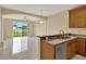 Open kitchen with granite countertops and a view of the living room and backyard through sliding glass doors at 540 Monroe Cir, Davenport, FL 33896
